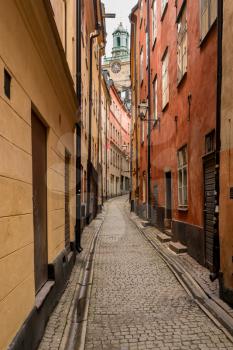 Narrow street between homes in the old town of Gamla Stan in Stockholm, Sweden