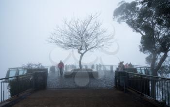 FUNCHAL, MADIERA - MARCH 12, 2018: Tourists lost in mist at Cabo Girao sea cliff near Funchal on Madiera