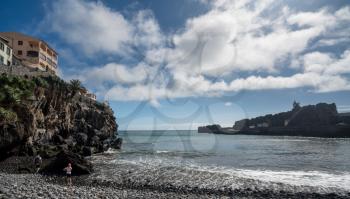 Tourists on beach at Camara de Lobos on island of Madiera