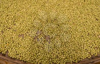 Large basket of green split peas drying inside Tulou in Fujian Province in China