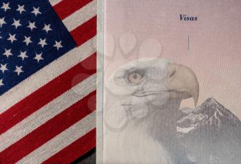 Detail of the visa page in a US passport against a USA flag background