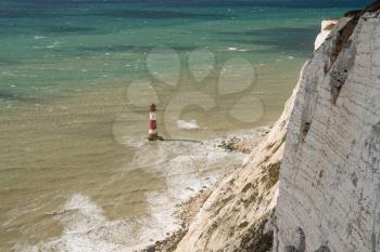 Strong winds creating waves around the Beachy Head Lighthouse near Eastbourne in East Sussex, UK