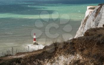 Strong winds creating waves around the Beachy Head Lighthouse near Eastbourne in East Sussex, UK