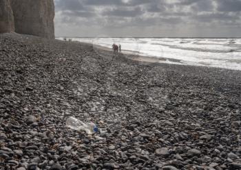 Plastic bottles blown onto the beach on stormy day at Birling Gap near Eastbourne