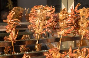 Small crabs dipped in batter and fried for crispy crab street food in Shanghai