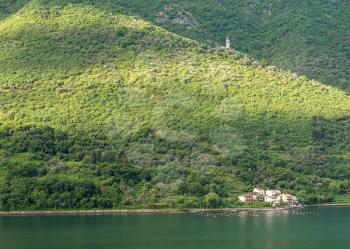 Small church on hillside of coastline of Gulf of Kotor in Montenegro