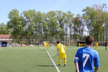 Football game. Training matches junior teams and fans.