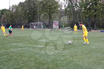 Football game. Training matches junior teams and fans.