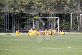 Football game. Training matches junior teams and fans.