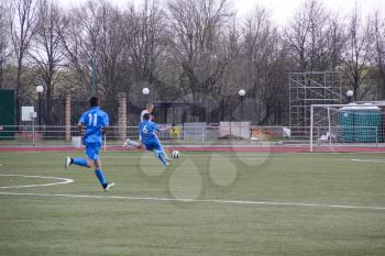 Football game. Training matches junior teams and fans.