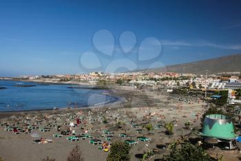 Costa Adeje, Tenerife, Spain - July 28, 2013: The islands of Tenerife is a resort for tourists. Coast of the sea and hotels on the beach.