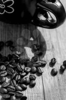 Hot Coffee cup and roast coffee beans on a wooden table and sack background.
