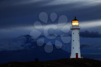 Cape Egmont Lighthouse and Taranaki Mount on background, New Zealand