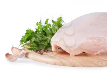 Raw chicken breast with green parsley and garlic