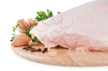Raw chicken breast with green parsley, spices and garlic