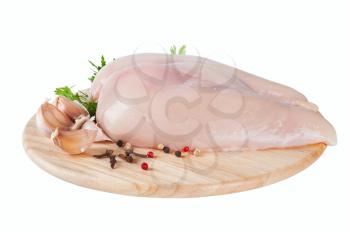 Raw chicken fillet on board with parsley and garlic