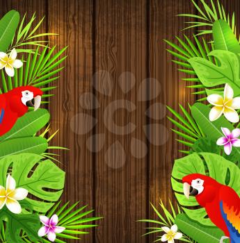 Green tropical leaves, flowers and red parrots on a wooden background.