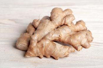 Fresh ginger root on a wooden table. Healthy food and spices.