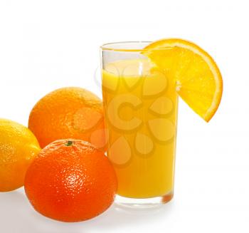 Fresh orange juice in the glass and citrus fruit lemons and oranges on a white background