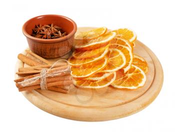 Dried orange slices, cinnamon and star anise on a wooden board. Spices for mulled wine isolated on a white background