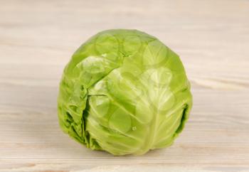 Fresh white cabbage on a wooden background. Vegetarian and diet food concept. 