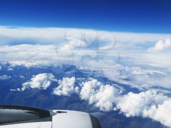 Engine of the plane on blue sky and clouds background