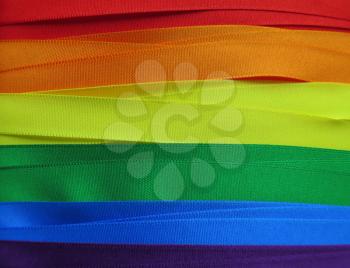 Gay Flag flag or banner made with red, orange, yellow, green, blue and purple ribbons