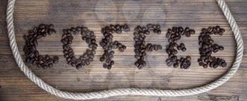 wooden board with a rough texture and the word Coffee