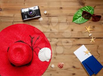 top view set of women's beach accessories and things for relaxation on a wooden brown background