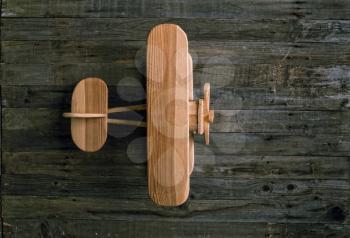 children's wooden airplane biplane stands on a rough wooden table