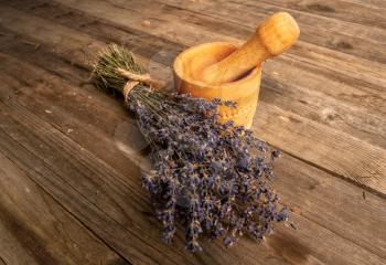 Bunch of dried lavender flowers on a rough wooden background