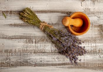 Bunch of dried lavender flowers on a rough wooden background