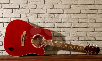 beautiful classical acoustic guitar on an old brick background