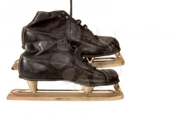 old leather hockey shoes with skates hanging on laces on white background