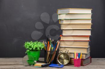 Education concept - books on the desk in the auditorium