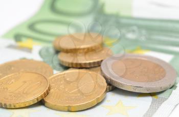 Euro coins placed on the Euro bank note.