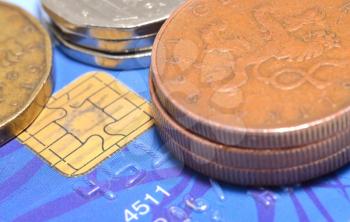 Macro shot of credit card and czech currency, coins.