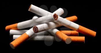 A pile of cigarettes on a black background.