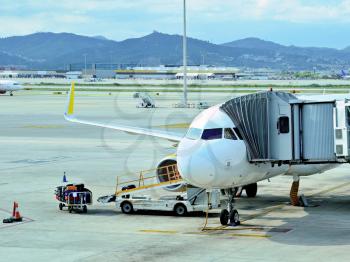 Passenger jet plane at apron in Barcelona El Prat airport. 