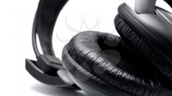 Black headphones on the white background. Closeup shot.