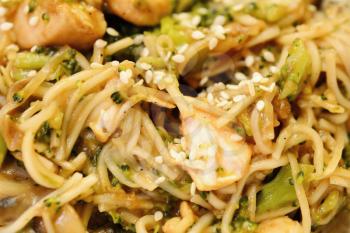 Chinese noodles with chicken meat, broccoli and vegetables.