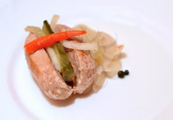 Portion of one traditional czech pickled sausage in sour brine with cucumber, onions and red hot peppers.