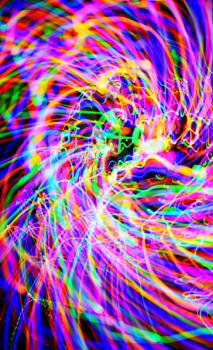 Abstract multi-color light trails shot with long exposure at night. Light painting.