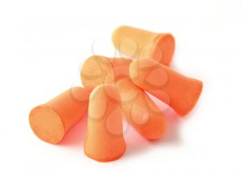 Heap of soft foam orange ear plugs over white background.