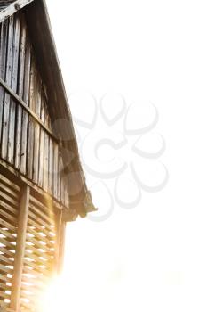 Old wooden barn and the sun