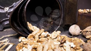 Wallnuts and hand walnuts grinderon a wooden surface