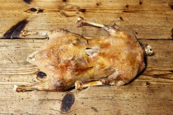 Roasted goose on wooden table 