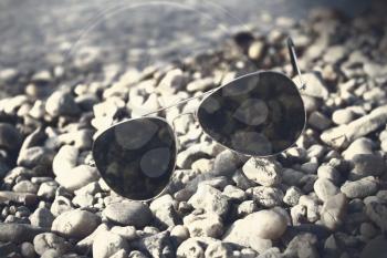 Sunglasses resting on the beach