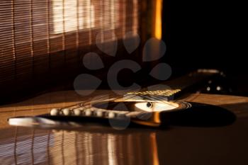 Acoustic Guitar In Music Studio Close up. Shined By The Sun At The Golden Hour 