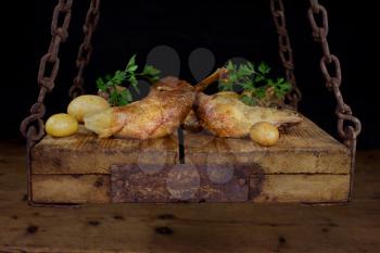 Roasted Goose Meat Served With Potatoes, Stuffing and Fresh Parsley On a Wooden Surface